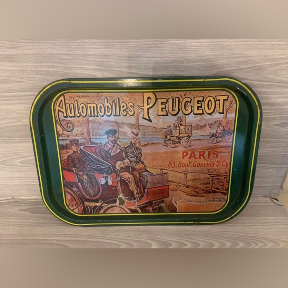 Vintage metal tray printed with an old Peugeot advertisement. See all photos